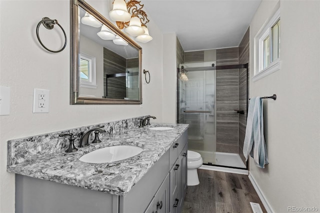 8979 Lariat Loop, Elizabeth, CO 80107 - bathroom with wood finished floors, double vanity, and a stall shower