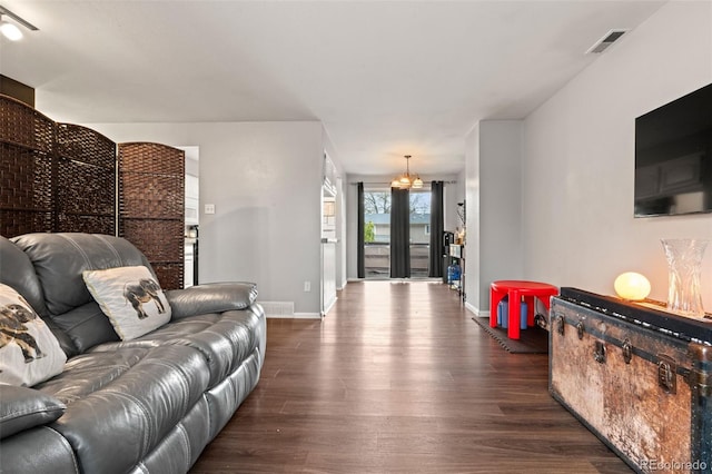living area featuring baseboards and dark wood-style floors