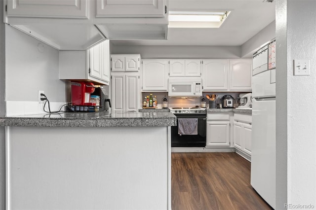 kitchen featuring white appliances, dark wood-style flooring, white cabinetry, and a peninsula