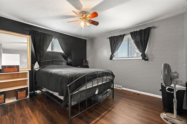 bedroom with wood finished floors, baseboards, and ceiling fan