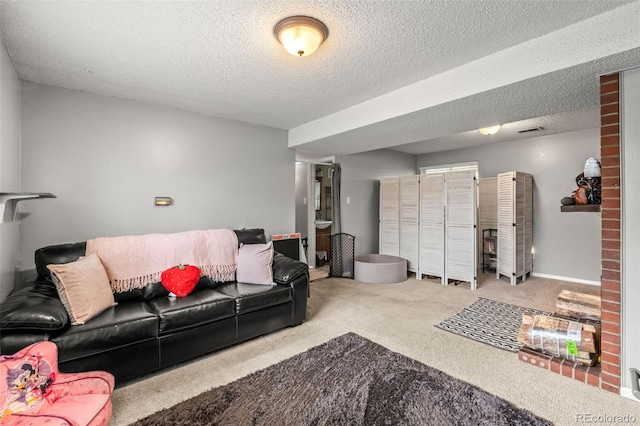 carpeted living area with a textured ceiling