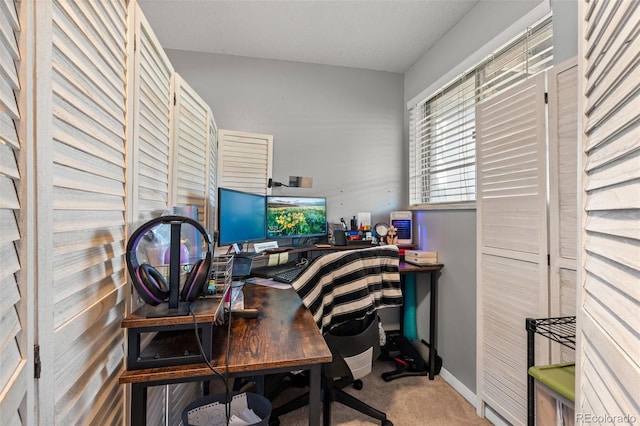 carpeted home office featuring baseboards