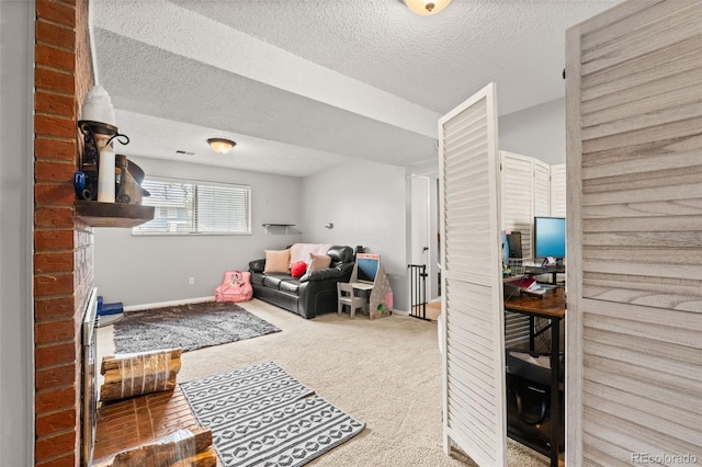 rec room featuring a textured ceiling, baseboards, and carpet floors