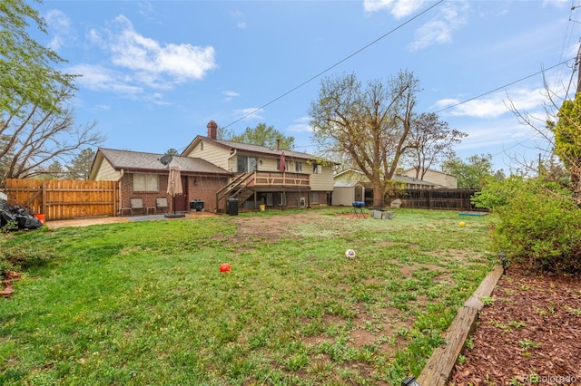 view of yard featuring a wooden deck, a patio area, and stairway