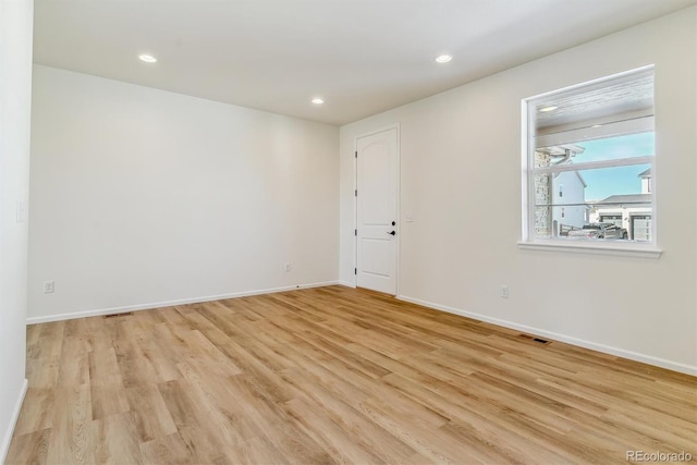 spare room featuring light hardwood / wood-style floors