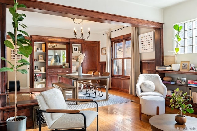 sitting room featuring a notable chandelier and light hardwood / wood-style flooring