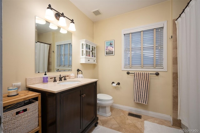 bathroom featuring tile patterned flooring, vanity, a shower with curtain, and toilet