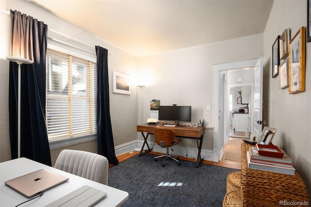 office area with plenty of natural light and dark wood-type flooring