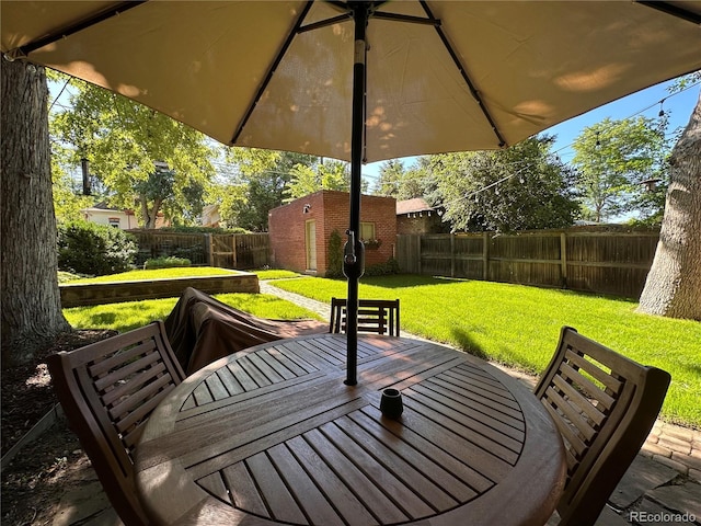 view of patio featuring an outbuilding