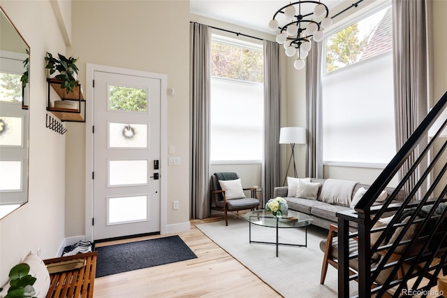 619 S High St, Denver, CO 80209 - foyer featuring light wood-type flooring, a chandelier, and baseboards
