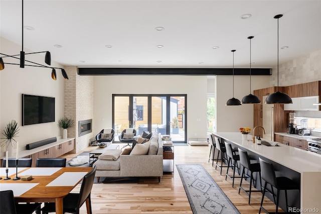 619 S High St, Denver, CO 80209 - living area with light wood-style floors, recessed lighting, and a fireplace