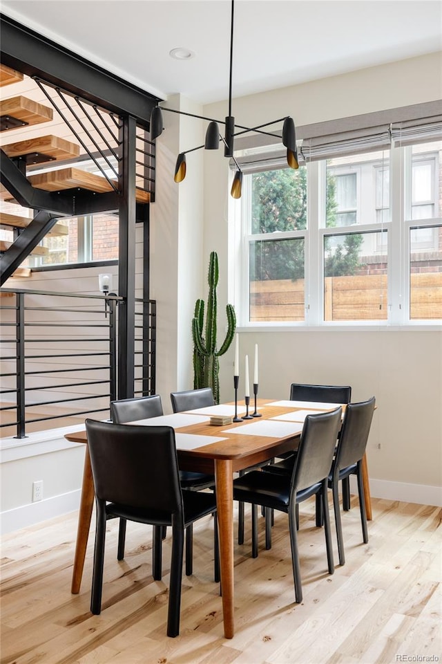 619 S High St, Denver, CO 80209 - dining area featuring light wood-type flooring, baseboards, and stairs