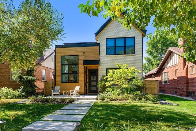 619 S High St, Denver, CO 80209 - view of front of property featuring a front yard and brick siding