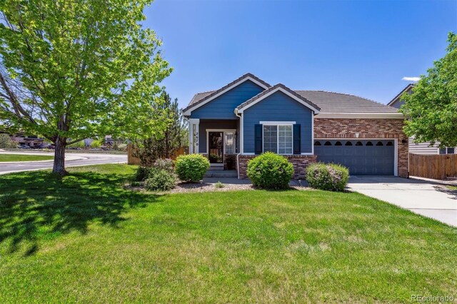2670 E 136th Pl, Thornton, CO 80602 - view of front of property featuring an attached garage, driveway, a tile roof, and brick siding