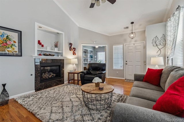 2670 E 136th Pl, Thornton, CO 80602 - living room featuring ornamental molding, wood finished floors, ceiling fan, plenty of natural light, and vaulted ceiling