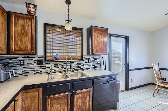 kitchen with pendant lighting, black dishwasher, sink, backsplash, and light tile patterned floors