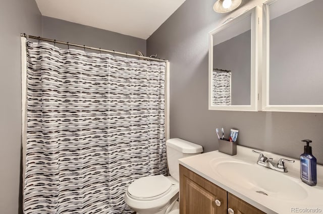 bathroom with vanity, curtained shower, and toilet