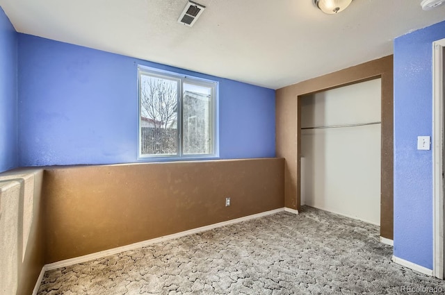 unfurnished bedroom with a closet and carpet