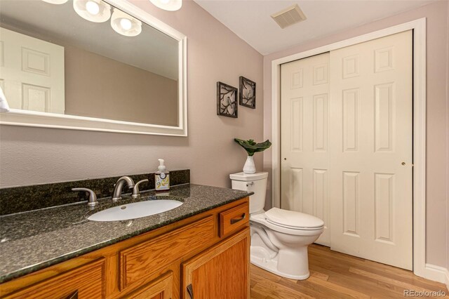 8588 S Woody Way, Highlands Ranch, CO 80126 - bathroom featuring wood finished floors and vanity