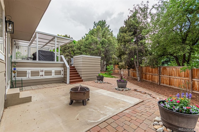 8588 S Woody Way, Highlands Ranch, CO 80126 - fenced backyard featuring stairway, a fire pit, and a patio area