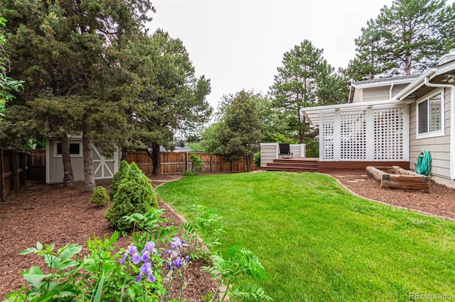 8588 S Woody Way, Highlands Ranch, CO 80126 - fenced backyard with a storage unit and a wooden deck