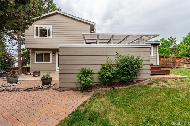 8588 S Woody Way, Highlands Ranch, CO 80126 - rear view of house with a patio and a fenced backyard