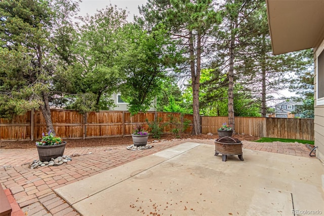 8588 S Woody Way, Highlands Ranch, CO 80126 - fenced backyard featuring a patio and an outdoor fire pit