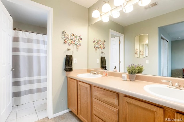 full bath featuring visible vents, a sink, and double vanity