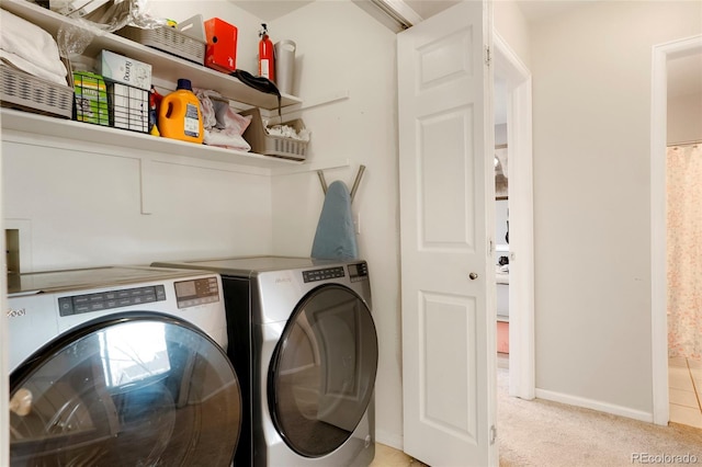 laundry area featuring carpet floors, washer and dryer, laundry area, and baseboards