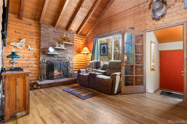 9061 N Rex Ln, Conifer, CO 80433 - living area with wood ceiling with exposed beams, a stone fireplace, wood-type flooring, rustic walls, and high vaulted ceiling