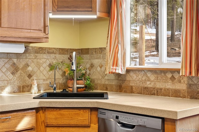 9061 N Rex Ln, Conifer, CO 80433 - kitchen featuring dishwasher, a sink, light countertops, and decorative backsplash
