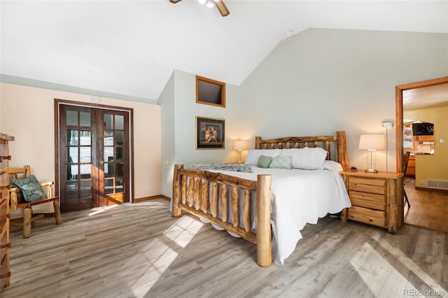 9061 N Rex Ln, Conifer, CO 80433 - bedroom featuring french doors, wood finished floors, baseboards, a ceiling fan, and high vaulted ceiling
