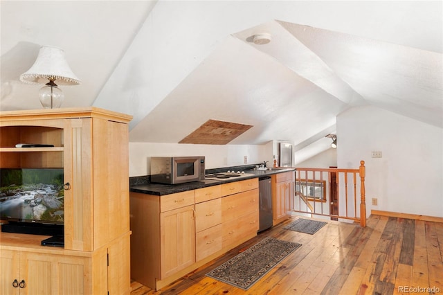 9061 N Rex Ln, Conifer, CO 80433 - kitchen with appliances with stainless steel finishes, light brown cabinets, light wood-type flooring, vaulted ceiling, and dark countertops