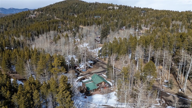 9061 N Rex Ln, Conifer, CO 80433 - aerial view of property and surrounding area featuring a heavily wooded area and a mountain backdrop