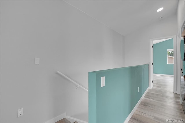 3470 W Walsh Pl, Denver, CO 80219 - corridor featuring wood finished floors, vaulted ceiling, and an upstairs landing