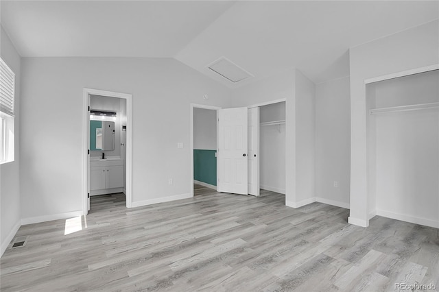 3470 W Walsh Pl, Denver, CO 80219 - unfurnished bedroom with two closets, attic access, light wood-style floors, vaulted ceiling, and ensuite bathroom