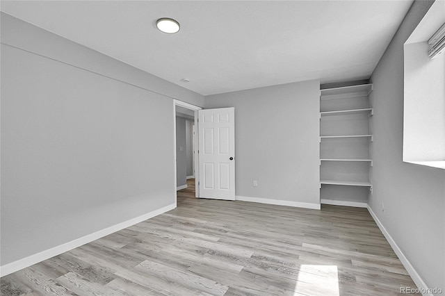 3470 W Walsh Pl, Denver, CO 80219 - unfurnished bedroom featuring wood finished floors, a walk in closet, and a closet