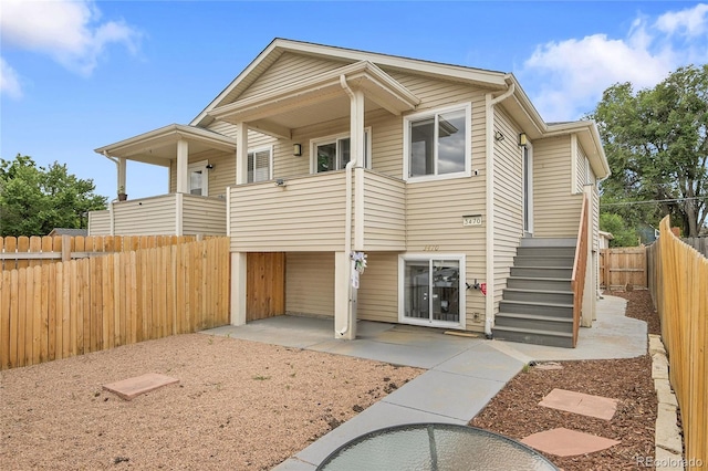 3470 W Walsh Pl, Denver, CO 80219 - view of front of house with a fenced backyard, a balcony, and a patio