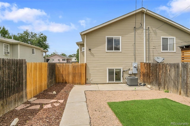 3470 W Walsh Pl, Denver, CO 80219 - back of house featuring a fenced backyard, a patio, and cooling unit