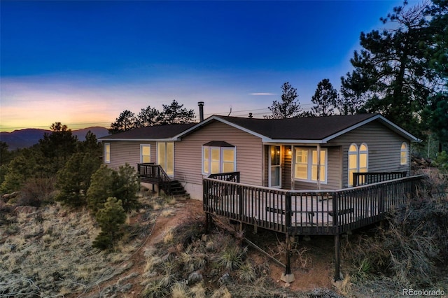 rear view of property with a wooden deck