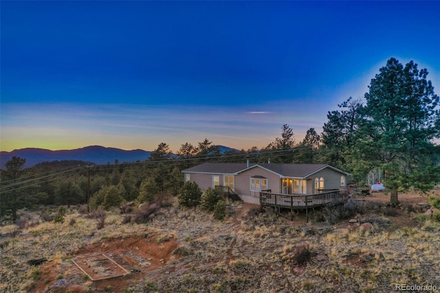 exterior space with a deck with mountain view