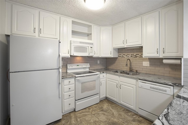 kitchen with stone counters, sink, white cabinets, decorative backsplash, and white appliances