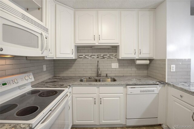 kitchen with decorative backsplash, sink, white appliances, and white cabinets