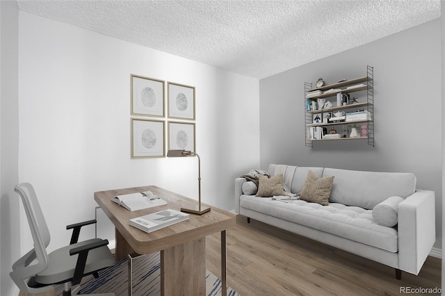 office area with hardwood / wood-style flooring and a textured ceiling