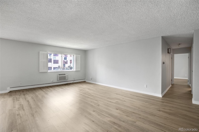 unfurnished room featuring a textured ceiling, baseboard heating, and wood-type flooring