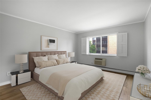 bedroom featuring a baseboard heating unit, a wall mounted AC, wood-type flooring, and ornamental molding