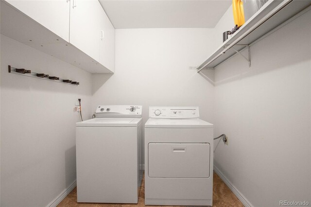 laundry room with independent washer and dryer, tile patterned flooring, and cabinets