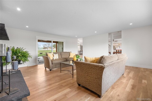 living area featuring light wood-style floors and recessed lighting