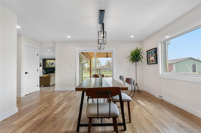dining space with light wood-type flooring, baseboards, and recessed lighting