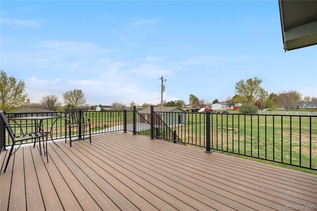 wooden terrace with a lawn